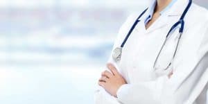 Physician standing in hallway.